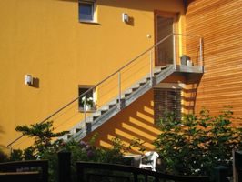 Außentreppe auf gelber Wand